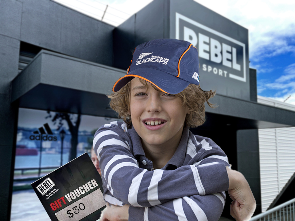 Wynter Gibson with gift voucher in hand ahead of Rebel Sport Boxing Day sale