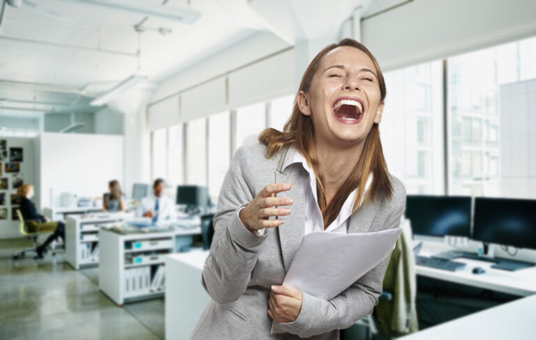 Kelly Higgins laughing in office.