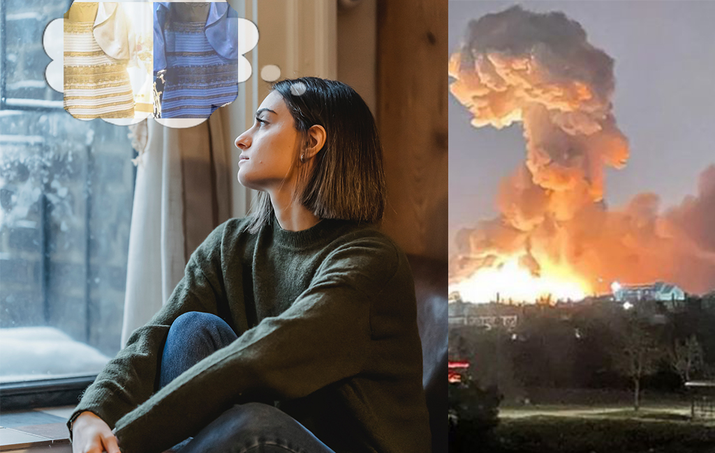Woman thinking of blue black dress next to Ukraine explosion