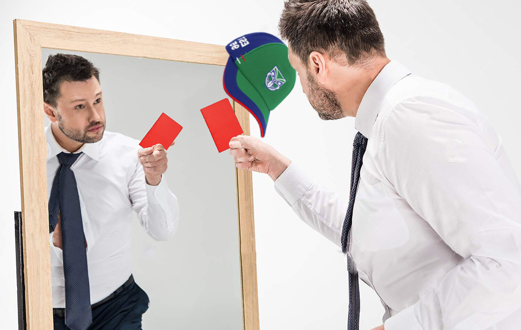 man shows himself red card in mirror
