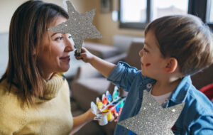 boy making matariki stars with mum
