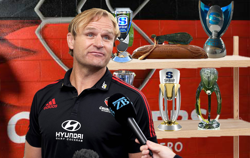 Scott Robertson next to super rugby trophies