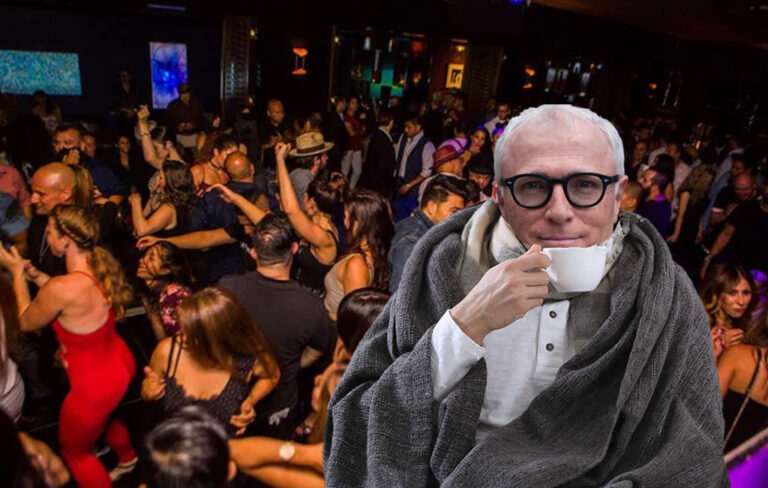 Michael Baker enjoying a cup of tea while pub-goers happily party without masks.