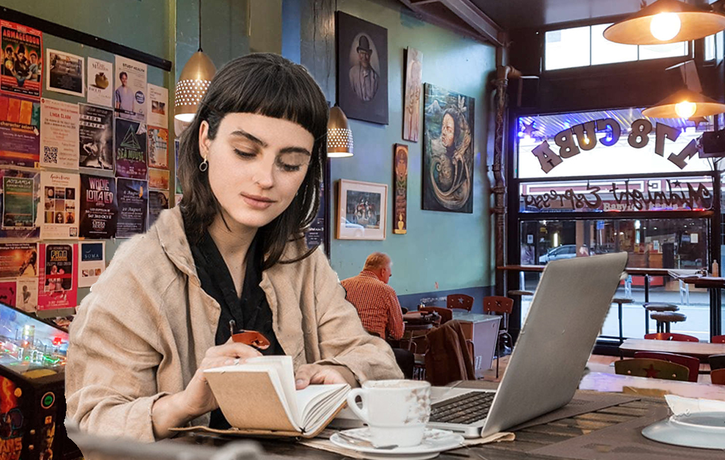 young woman with laptop at cafe