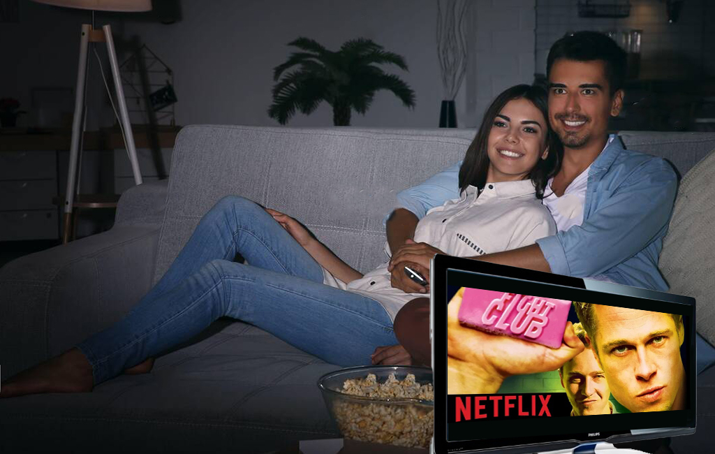 couple sitting on the couch watching netflix