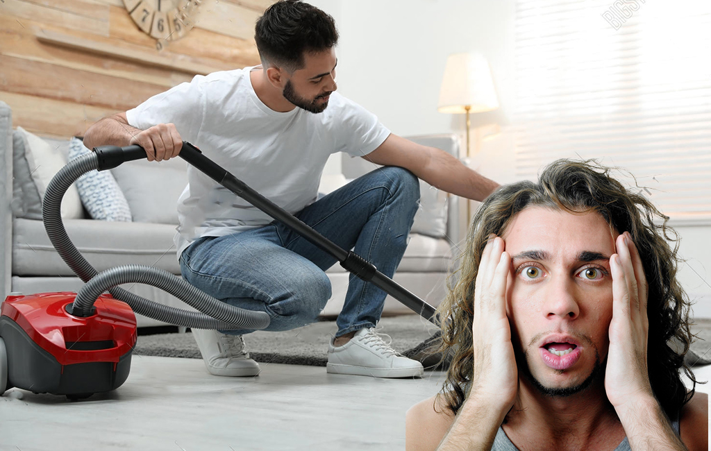man shocked by other man vacuuming