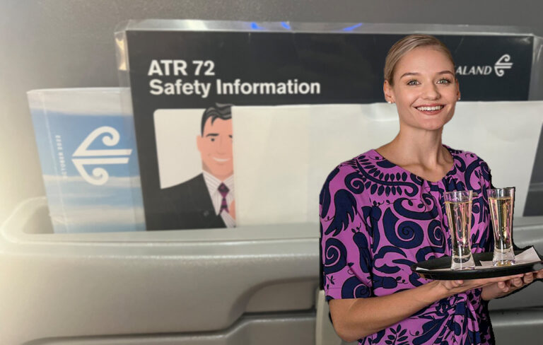 air nz flight attendant with sickbag in background