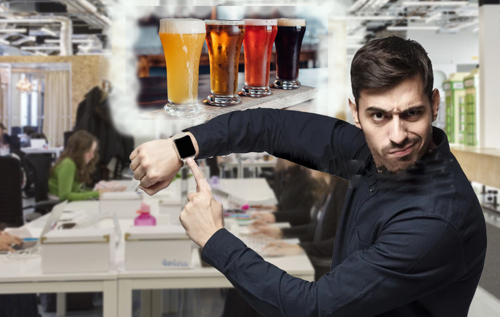 man tapping watch at office, wanting to go for drinks