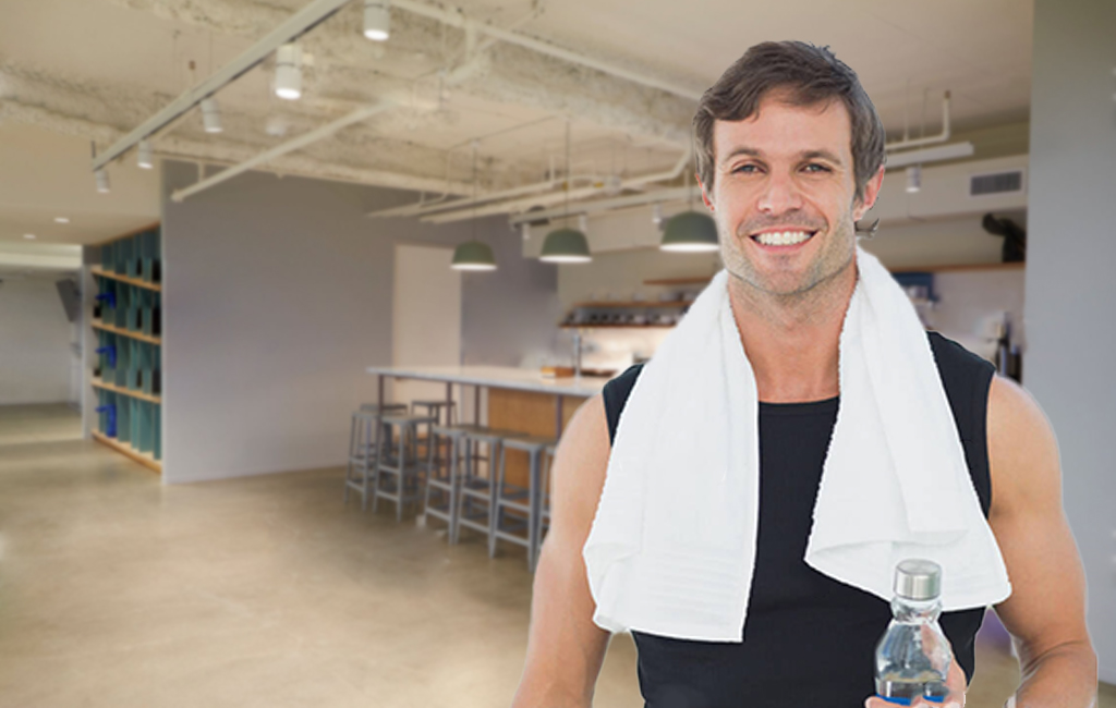 Man in exercise gear in office kitchen