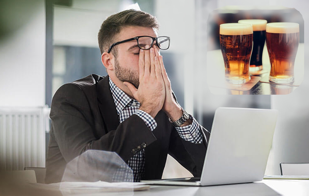 man tired at laptop, thinking about beers