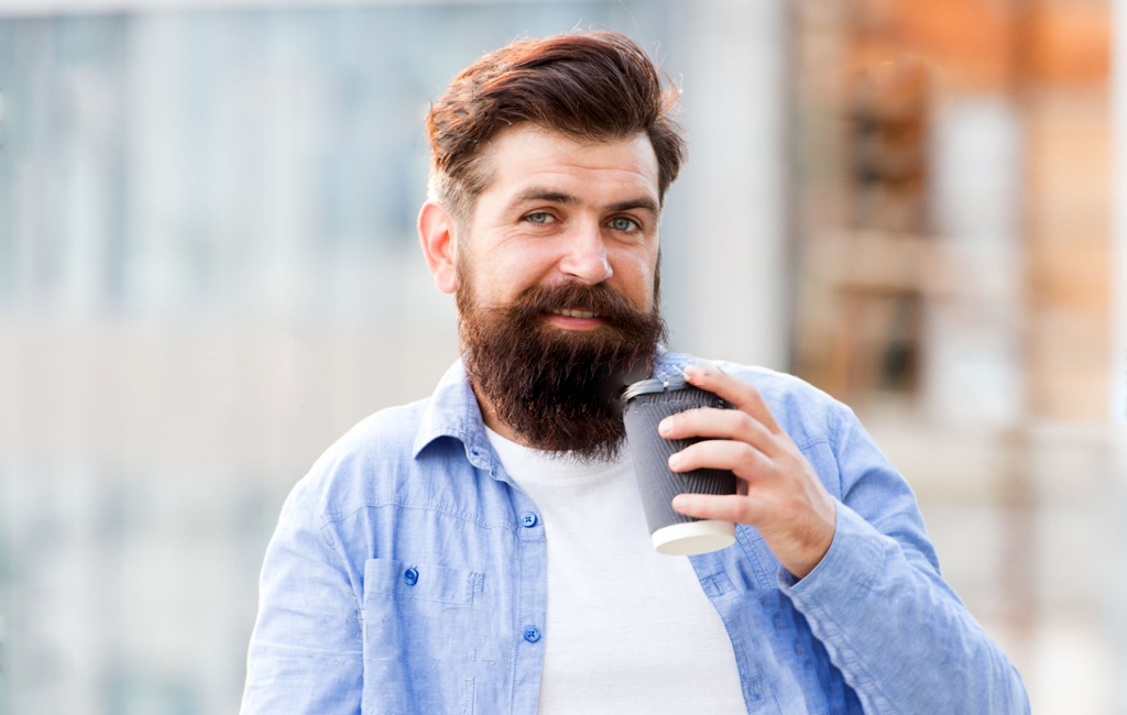 Bearded man with takeaway coffee