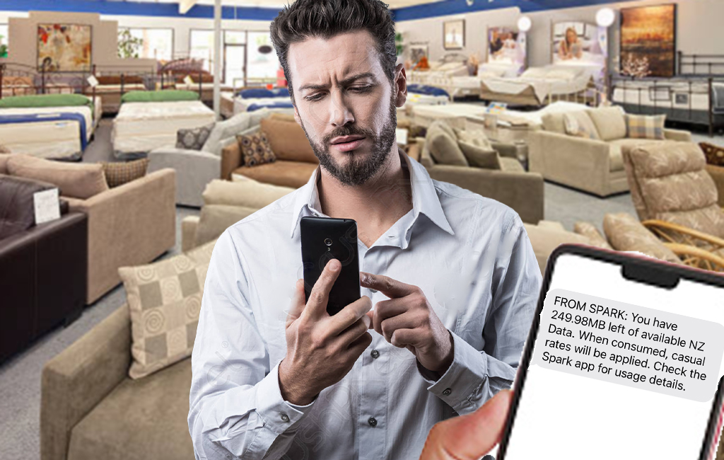 Man looking at phone in furniture shop