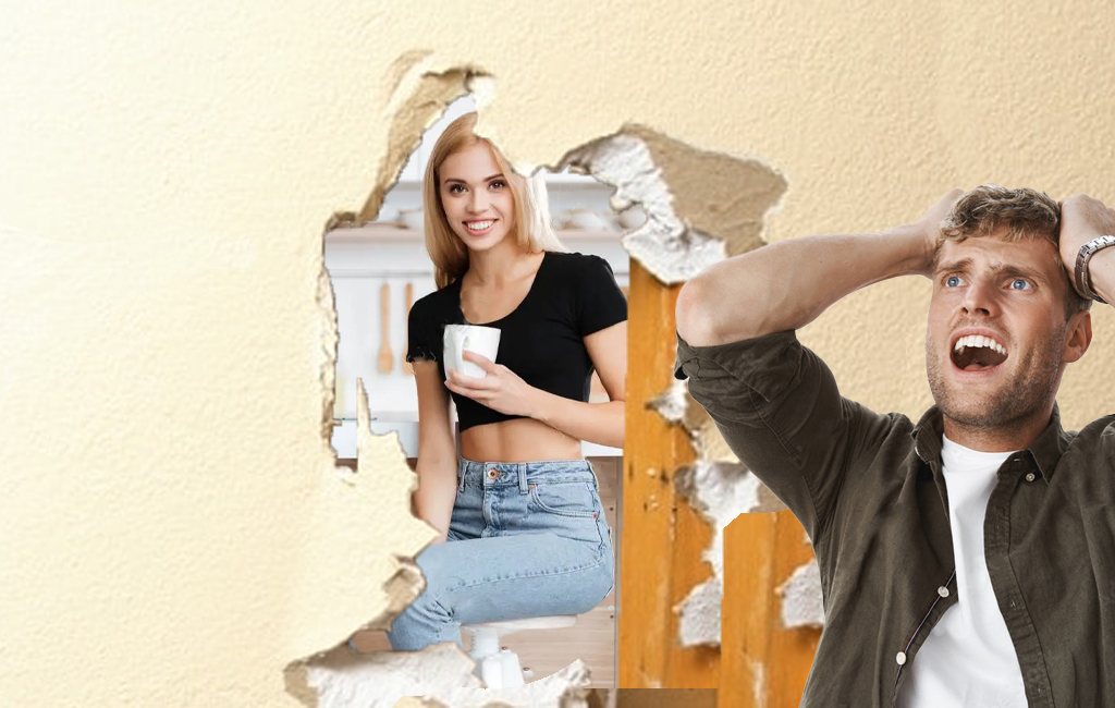 woman happily sitting in the kitchen and can be seen through hole in the wall by husband