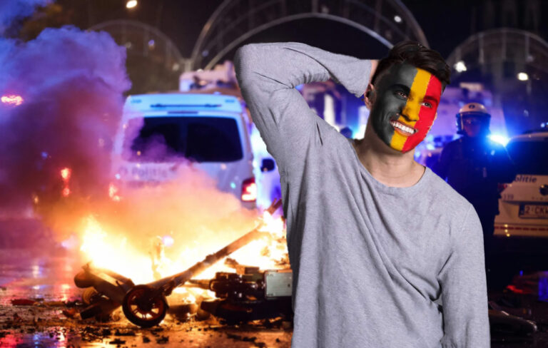 man with belgium flag face paint standing awkwardly with fire in the background