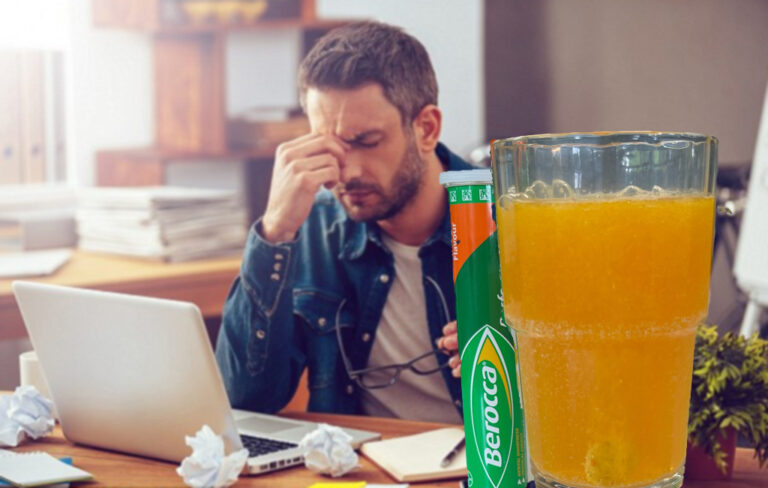 man slumped at desk with berocca