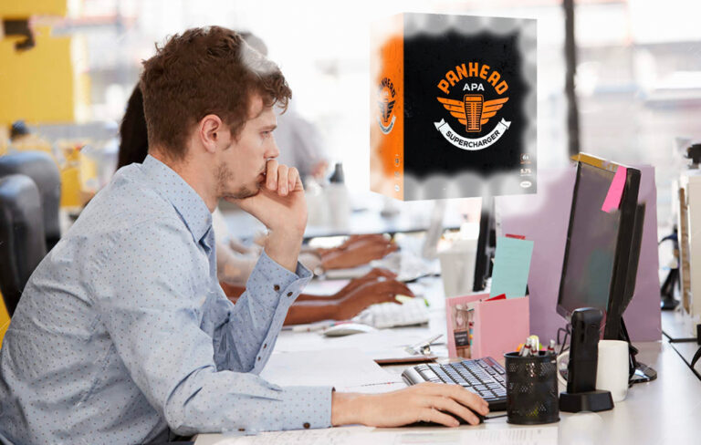 Man working at his desk while thinking of beers.