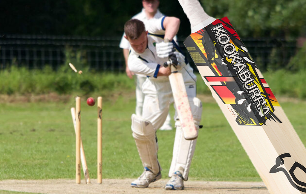 batsman getting cleaned up with brand new kookaburra bat in foreground.