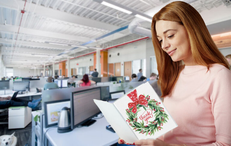 woman reading christmas card in office