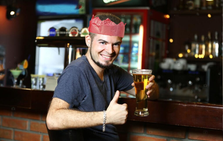 man at bar with beer