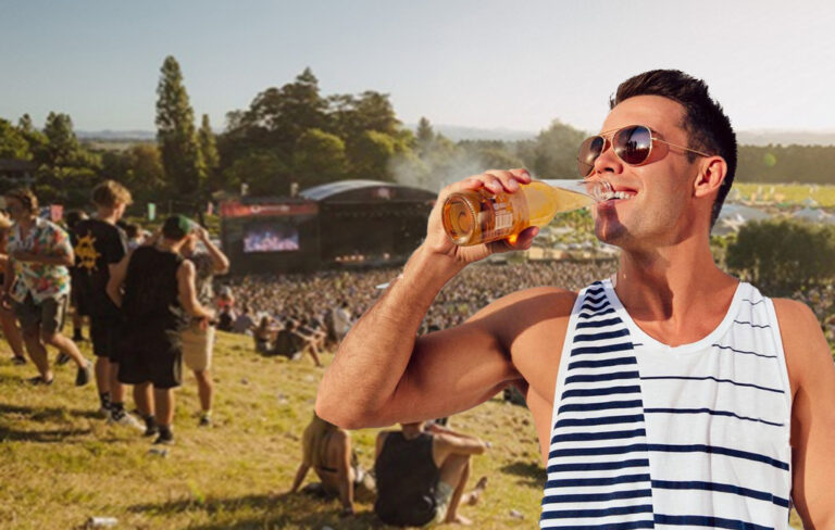 man in singlet drinking beer at festival