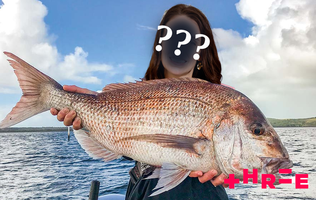 Mystery woman on boat holding fish.