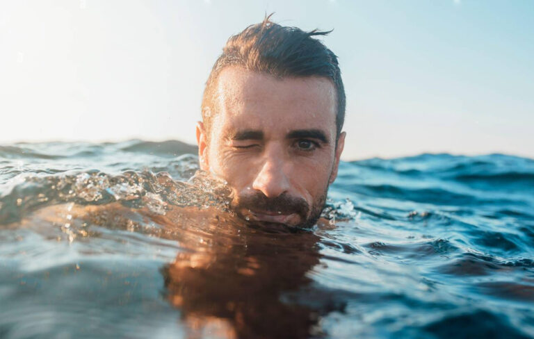 man swimming in ocean