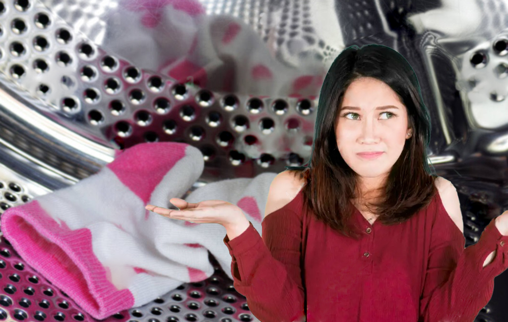 woman shrugging in front of inside of washing machine with pink polka dot sock.