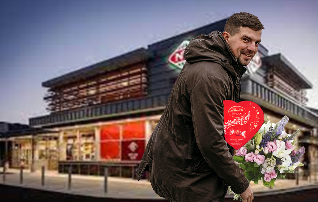 man with flowers outside New World supermarket