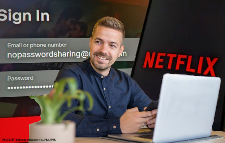 man on laptop with netflix branding in background