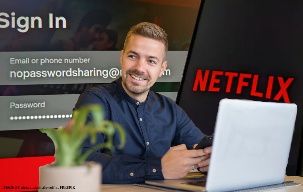 man on laptop with netflix branding in background