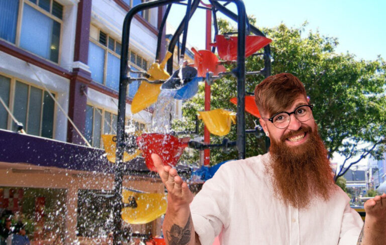 man in front of bucket fountain on cuba street