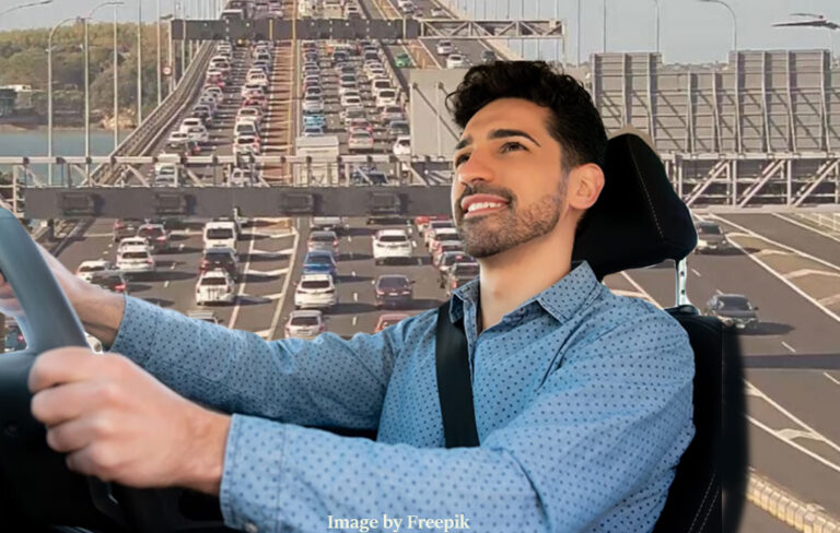 driver smiling, while background is Auckland's gridlock traffic.