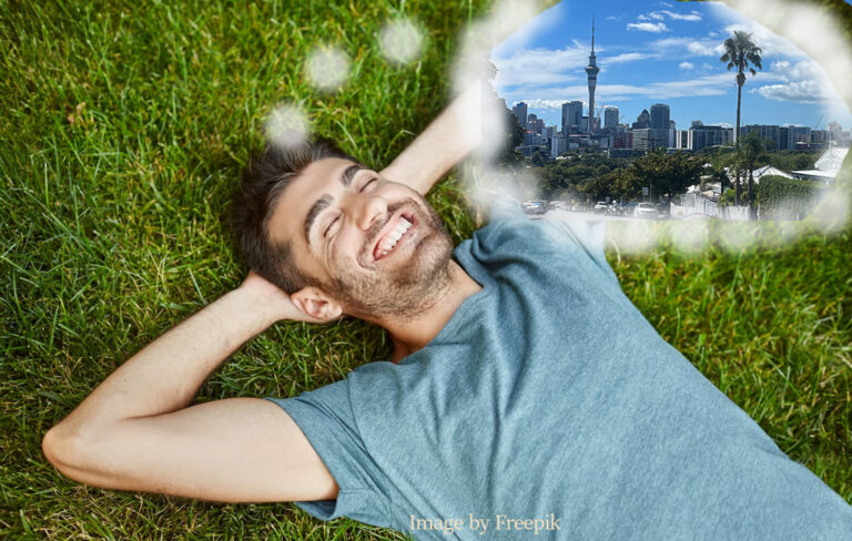 man relaxing on the grass, thinking of auckland.