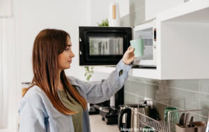 mum retrieving cold coffee from microwave