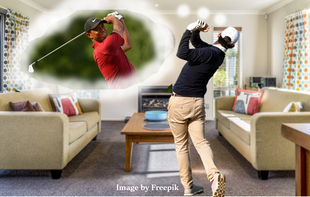 man swinging golf club in lounge, thinking about tiger.