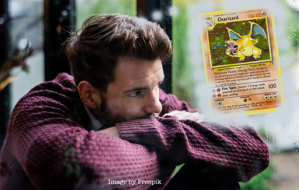 depressed man thinking about charizard pokemon card.