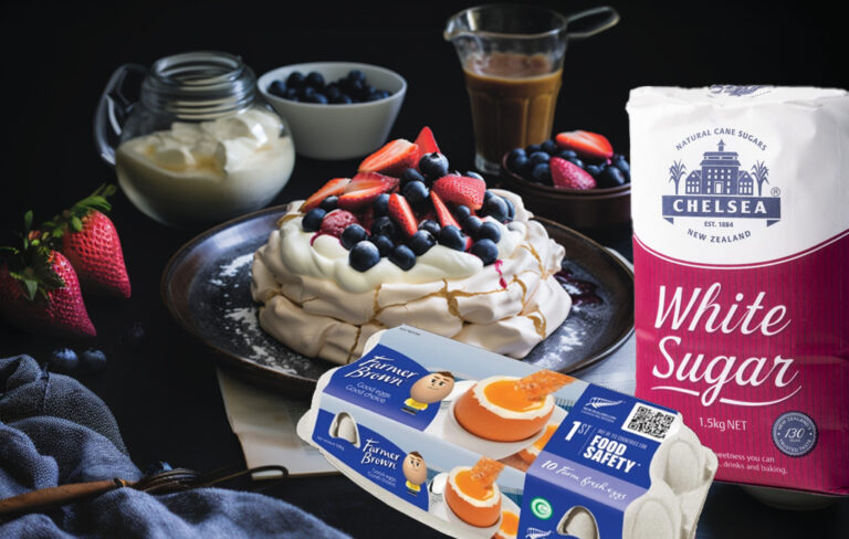 pavlova with bag of chelsea sugar and farmer brown's egg carton.