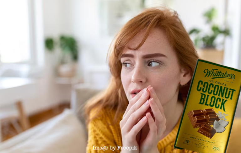 Woman looking away nervously with coconut block chocolate near her.