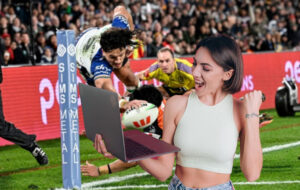 woman celebrating with laptop as warriors score try