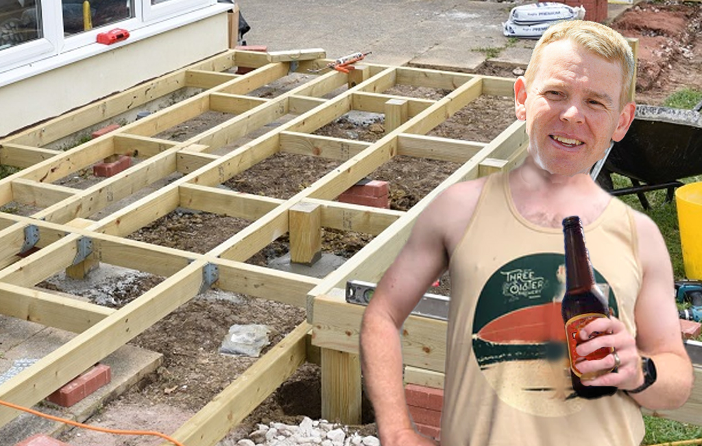 Chris Hipkins with a beer in front of half built deck