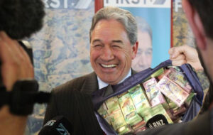 winston peters at press conference being offered bag of nz cash