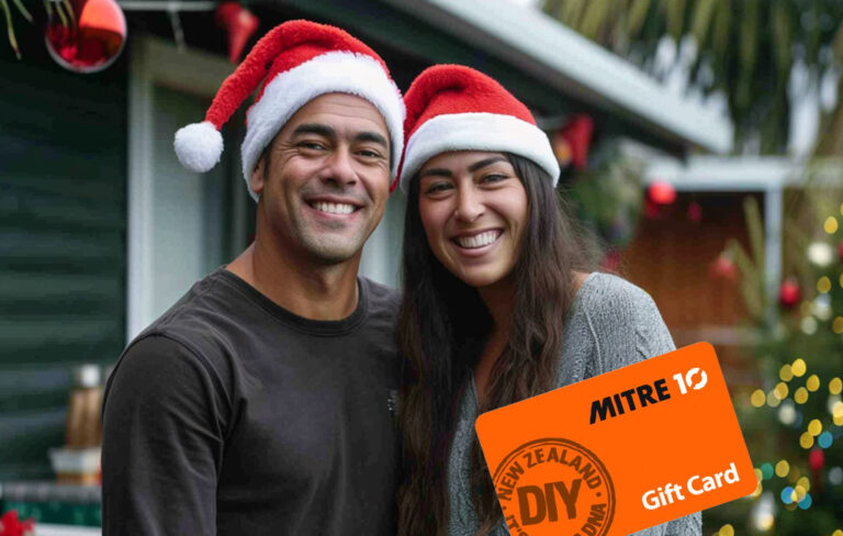 couple with santa hats and mitre 10 voucher