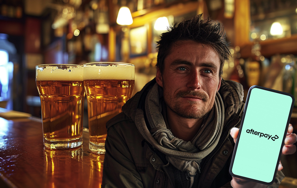 man in bar attempting to pay for beers with Afterpay on his phone