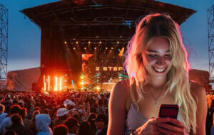 woman looking at phone during night time music festival