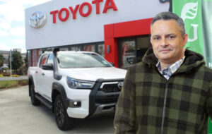 james shaw standing in front of toyota dealership and hilux