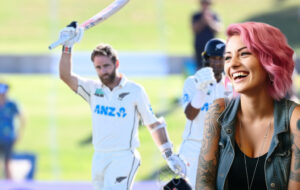 pink haired woman laughing at cricket
