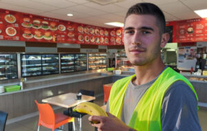 Tradie with banana in bakery