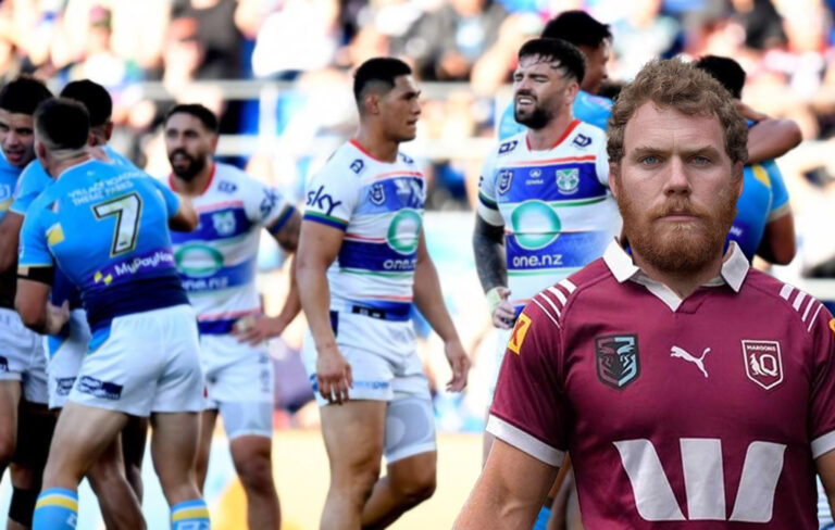 man wearing maroons top with losing warriors team in background