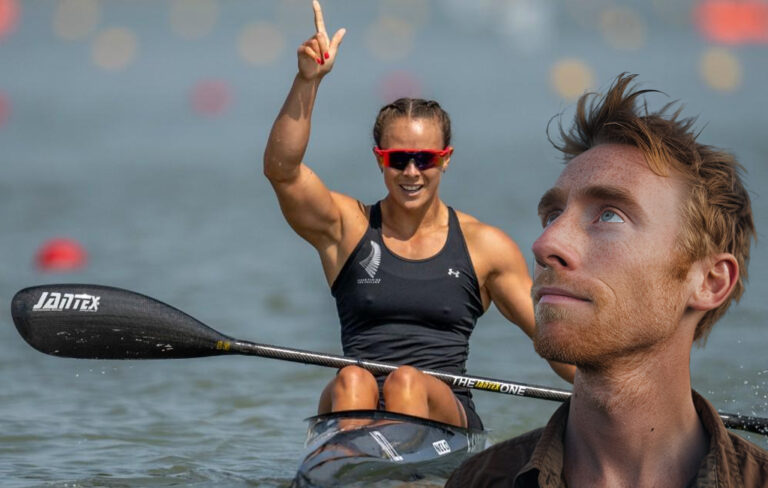 Man in foreground looking upward in wonderment, with lisa carrington canoeing in the background