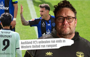 Phoenix fan with losing Auckland team behind and headline